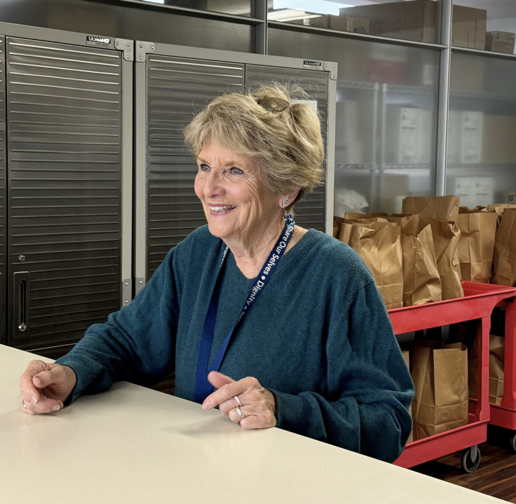 Volunteer Kathy Stefano at the Share Ourselves distribution window in Costa Mesa